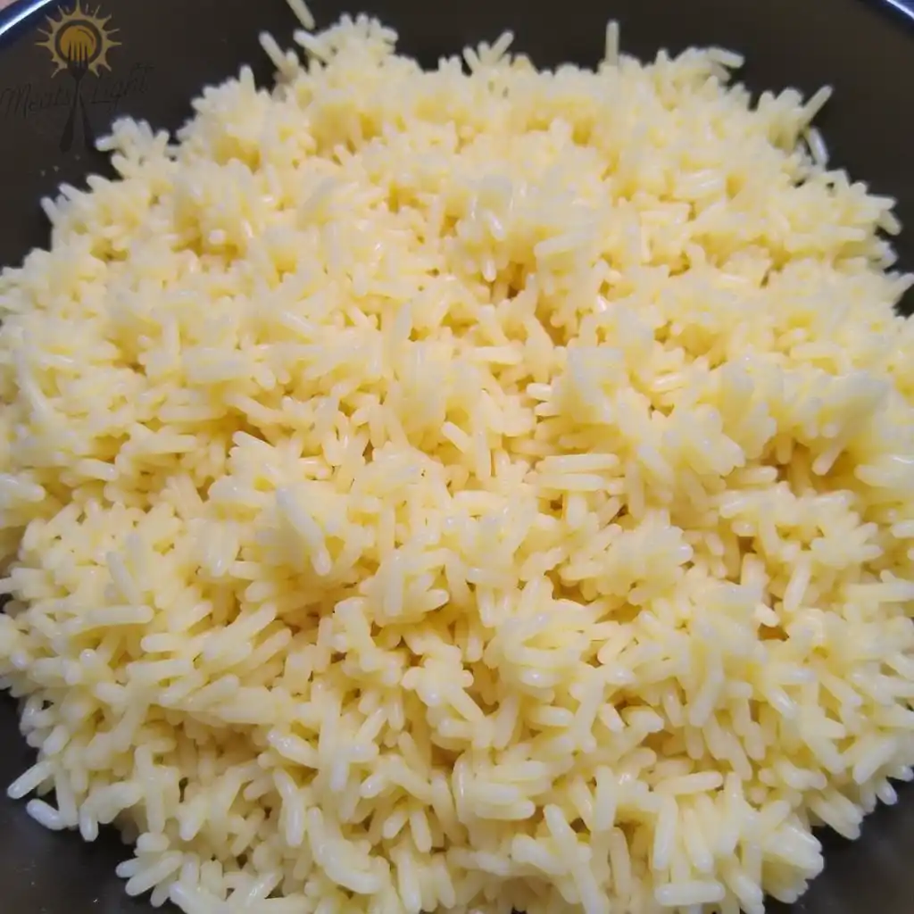 A close-up of cooked white rice in a bowl.