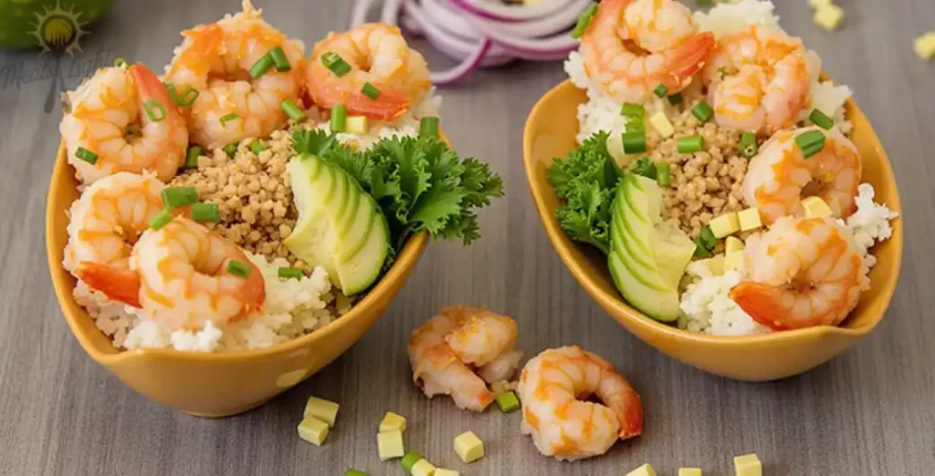 Bang Bang shrimp sushi bowl with rice, avocado, and spicy sauce, garnished with sesame seeds.